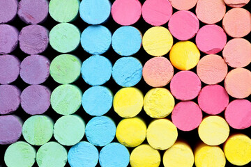 Colorful chalk for drawing on chalkboard on top view.