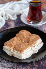 Cold baklava. Baklava with milk on a colored background. Turkish cuisine delicacies. close up