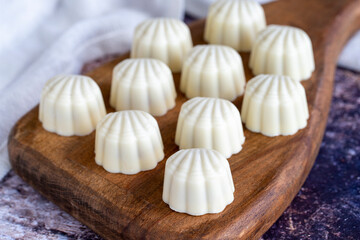 White chocolate. Special mussel-looking chocolate. Special chocolate on colored background. close up