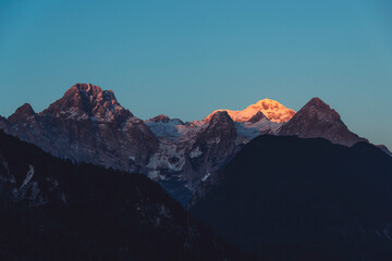 Winter peaks with fresh snow and clouds above it. 