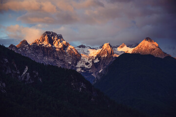 Winter peaks with fresh snow and clouds above it. 
