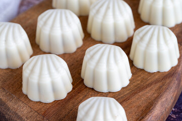 White chocolate. Special mussel-looking chocolate. Special chocolate on colored background. close up