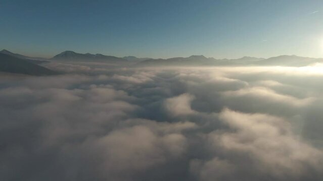 Above and through the clouds. Flying fpv at sunset at the bavarian Alps