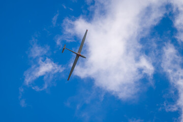 Free flight of sailplane in blue sky