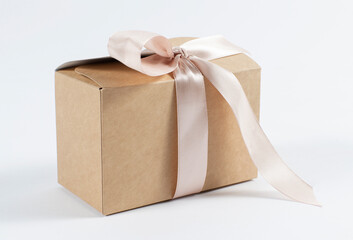 cardboard holiday box with pink ribbon. packaging example.