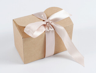 cardboard holiday box with pink ribbon. packaging example