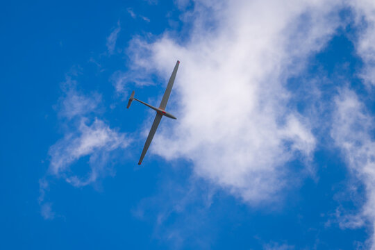 Free flight of sailplane in blue sky