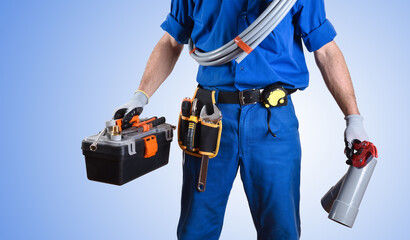 Detail of uniformed plumber with tools and blue isolated background