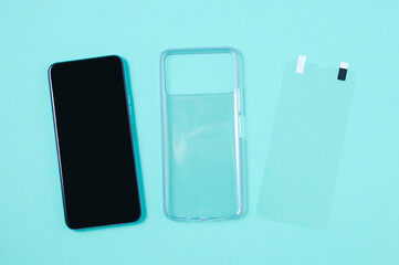 Smartphone protective transparent silicone case phone screen film. Turquoise background.