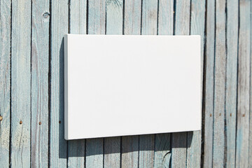 White stretched canvas mockup on wooden wall