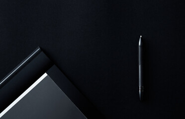 Electronic drawing pen tablet with pen stylus isolated on black background. Copy space. Banner....