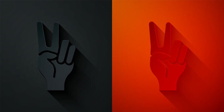 Paper cut Hand showing two finger icon isolated on black and red background. Hand gesture V sign for victory or peace. Paper art style. Vector