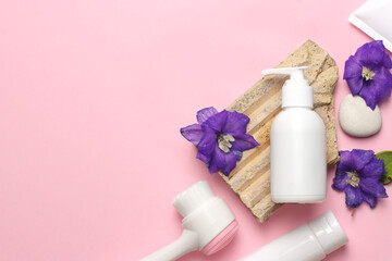 care products cream, lotion, flower. bath accessories on pink background, top view, copyspace. Face bodycare beauty treatments at home concept, organic bath products, morning routine