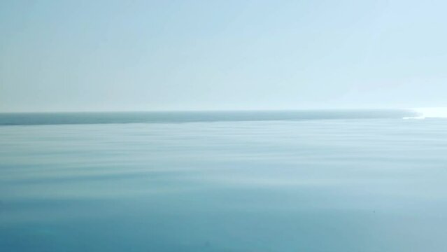 Landscape of  Beach Pool on Background of Sea, Water in Infinity Pool in Sunlight at Dawn.