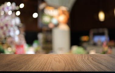 Empty wooden table in front of abstract blurred background of coffee shop . can be used for display or montage your products.Mock up for display of product