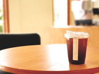 Ice coffee, americano coffee with orange in cafe.