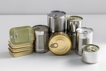 food, eating and preserve concept - close up of tin cans with preserves on table