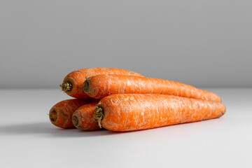 food, vegetables and healthy eating concept - close up of ripe carrots on table