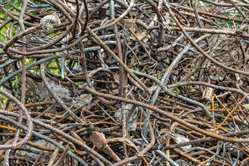 A textured surface of twisted rebar and wire that is piled into a large pile.