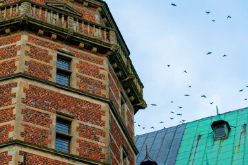 Detail from an old Renaissance Castle or Palace built from bricks and copper roofing. 