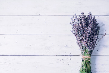 One bouquet of lavender flowers on a white wooden table