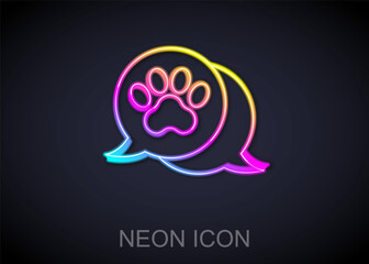 Glowing neon line Paw print icon isolated on black background. Dog or cat paw print. Animal track. Vector