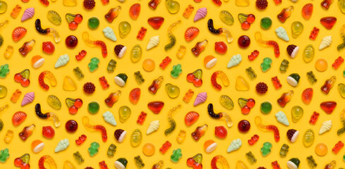 Seamless pattern of assorted gummies jelly gummy fruit sweets candy on yellow background top view...