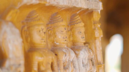 Closeup shot of carved headstone at Bada bagh in Jaisalmer, Rajasthan, India. Ancient head stone carved and made out of sand stone at Jaisalmer. Carved statues of old king on headstones at bada bagh. 