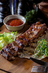 Grilled pork ribs in honey sauce and homemade adjika