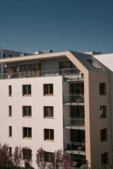 Modern low-rise apartment building. Condominium with white facades and windows