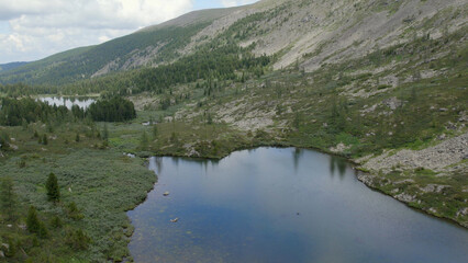 Karakol lakes in mountains of Altai under blue sky with white cloud