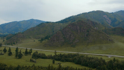 Obraz premium Road between field and mountains in Altai
