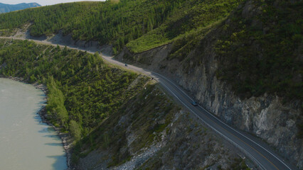 Fototapeta premium Traffic cars on Chuya highway road between mountains and Katun river in Altai