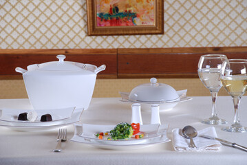 Elegant table setting with luxury china dinnerware. Golden design porcelain dishes.