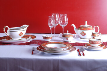 Elegant table setting with luxury china dinnerware. Golden design porcelain dishes.