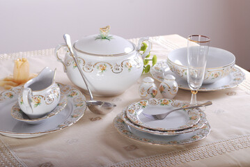 Elegant table setting with luxury china dinnerware. Golden design porcelain dishes.