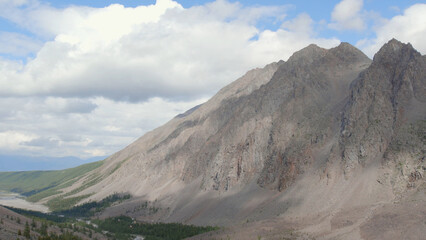 Fototapeta premium Mountains of Aktru valley with river and forest under white clouds in Altai
