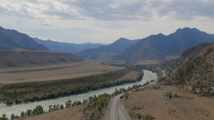 Fototapeta premium Mountains valley of Altai with blue Katun river under dramatic sky