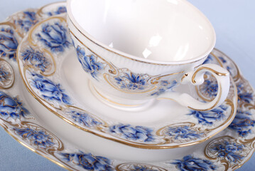Elegant table setting with luxury china dinnerware. Golden design porcelain dishes.