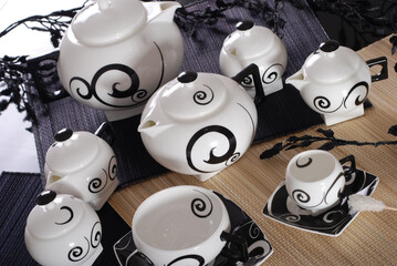 Beautiful bone-china tea set with tea pot and cups and saucers Elegant and minimal design.