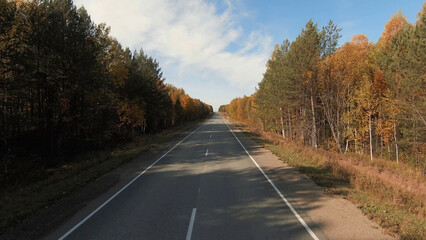 High-speed flight along the road and autumn forest