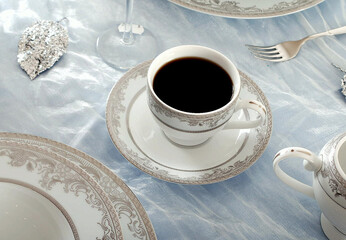Beautiful bone-china tea set with tea pot and cups and saucers. Minimal and elegant design.
