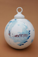 Porcelain globe for decorating the Christmas tree. Winter Holiday and Xmas ornament.