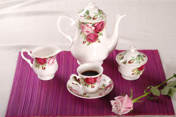 Beautiful bone-china tea set with tea pot and cups and saucers Elegant and minimal design.