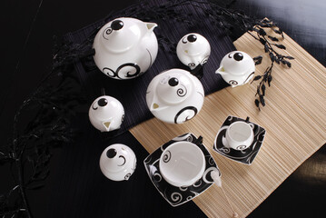 Beautiful bone-china tea set with tea pot and cups and saucers Elegant and minimal design.