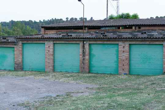 Image of garages with turquoise doors in an abandoned factory