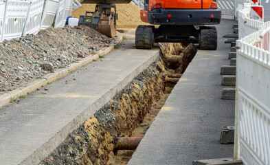Fototapeta na wymiar Construction site digging gas pipeline excavator