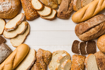 Homemade natural breads. Different kinds of fresh bread as background, top view with copy space