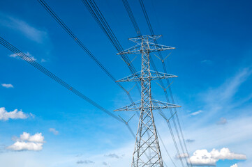 Standing street light post, electric pole and high voltage tower.High voltage transmission pole sunlight with blue sky background.