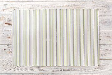 Top view of light tablecloth for food on wooden background. Empty space for your design